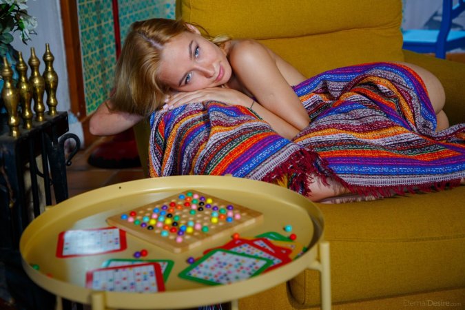 Kelly Collins posing on a yellow couch photo 2